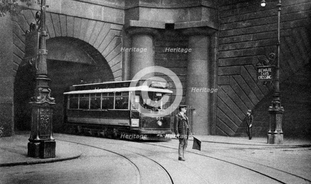 A tram running beneath Kingsway, Aldwych and Somerset House, London, 1926-1927. Artist: Unknown