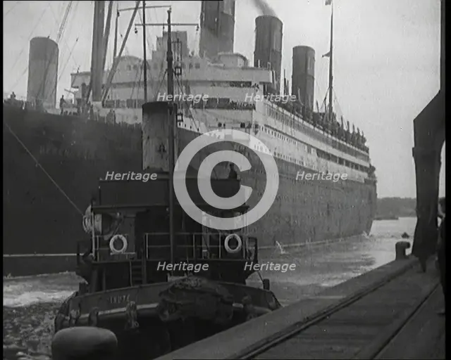 A Tugboat Pulling an Atlantic Liner into a Harbour, 1920s. Creator: British Pathe Ltd.