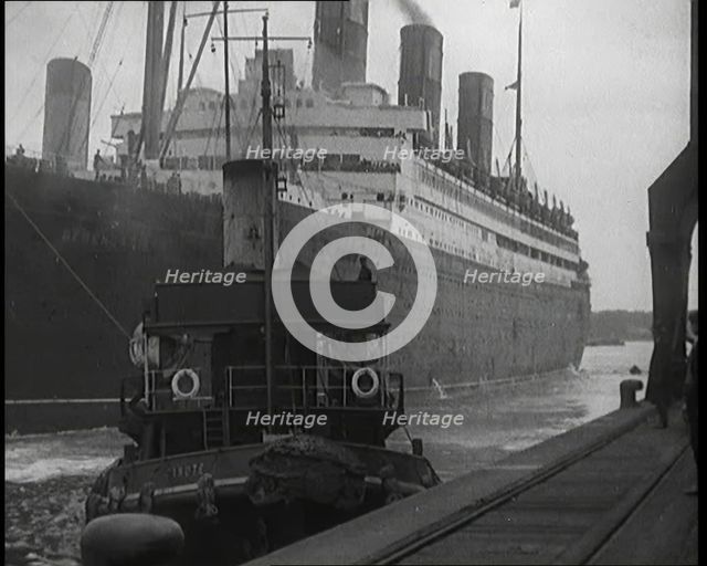 A Tugboat Pulling an Atlantic Liner into a Harbour, 1920s. Creator: British Pathe Ltd.
