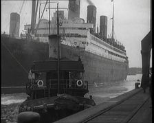 A Tugboat Pulling an Atlantic Liner into a Harbour, 1920s. Creator: British Pathe Ltd