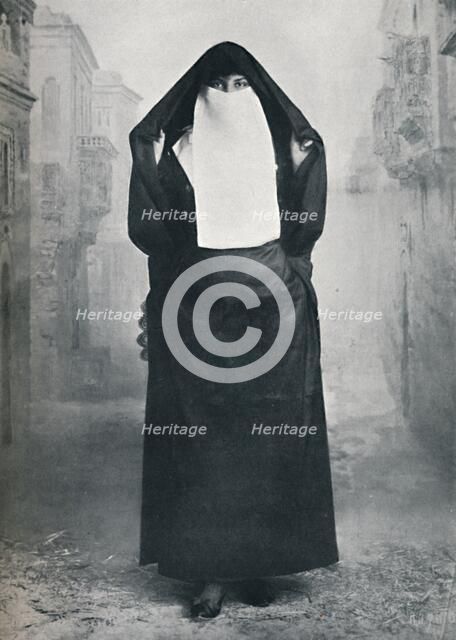 A Turkish lady in outdoor costume, 1912. Artist: Lekegian & Co.