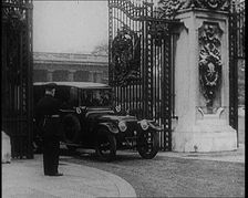 A Uniformed Male and a Male British Police Officer Standing Outside the Gates of Buckingham..., 1924 Creator: British Pathe Ltd
