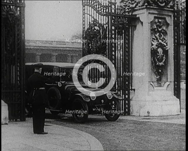 A Uniformed Male and a Male British Police Officer Standing Outside the Gates of Buckingham..., 1924 Creator: British Pathe Ltd.
