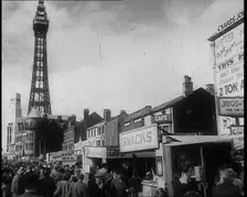 A View of Blackpool Promenade With the Blackpool Tower in the Distance and Shops and Kiosks..., 1939 Creator: British Pathe Ltd