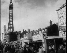 A View of Blackpool Promenade With the Blackpool Tower in the Distance and Shops and Kiosks..., 1939 Creator: British Pathe Ltd