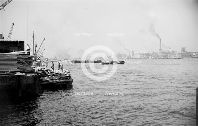 A view across the River Thames at Woolwich Reach, c1945-c1965. Artist: SW Rawlings
