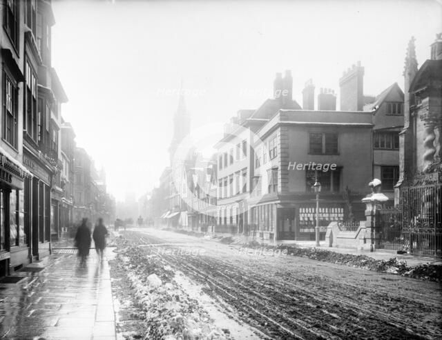 A view down the High Street with snow and slush in the road, Oxford, Oxfordshire, 1885. Creator: Henry Taunt.