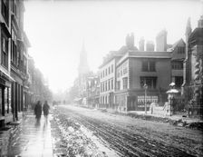 A view down the High Street with snow and slush in the road, Oxford, Oxfordshire, 1885. Creator: Henry Taunt