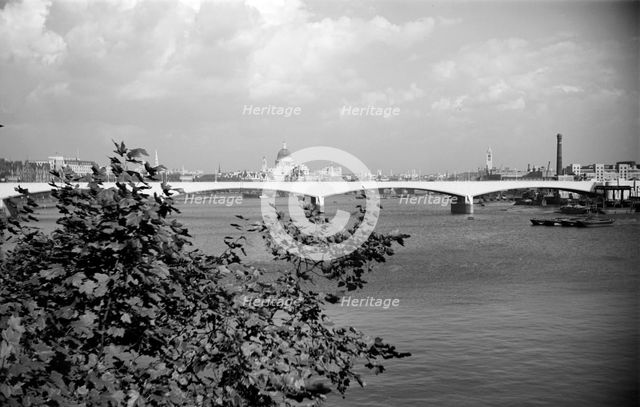 A view eastwards along the River Thames to Waterloo Bridge and the City of London, c1945-c1965 Artist: SW Rawlings
