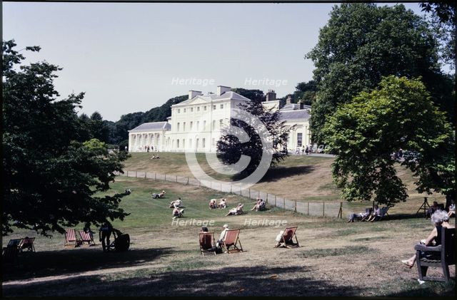 A view from the south-east looking towards Kenwood House, with people relaxing on the lawn..., 1984. Creator: Dorothy Chapman.