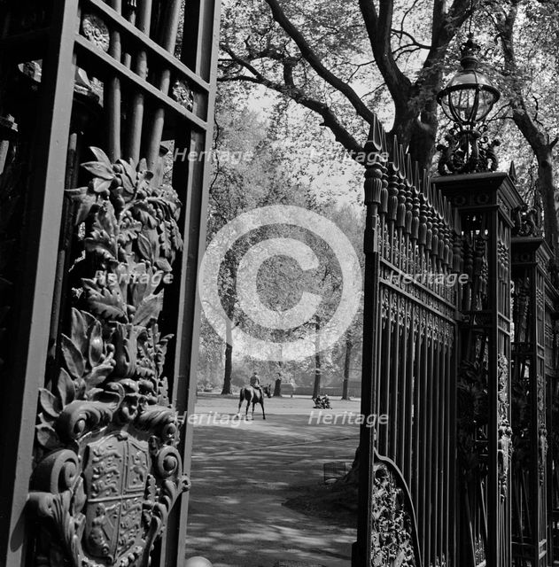 A view through one of the five pairs of elaborate cast iron gates, Queen's Gate, Hyde Park, 1955-65 Creator: John Gay.