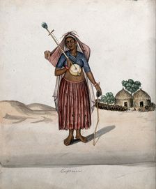 A village woman carrying a musical instrument in one hand, a stick with..., (between 1800 and 1899?) Creator: Unknown