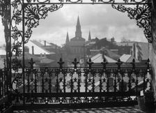 A vista through iron lace, New Orleans, between 1920 and 1926. Creator: Arnold Genthe