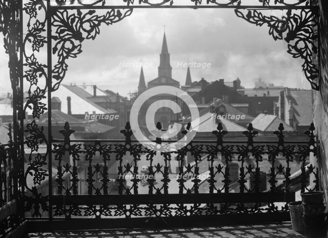 A vista through iron lace, New Orleans, between 1920 and 1926. Creator: Arnold Genthe.