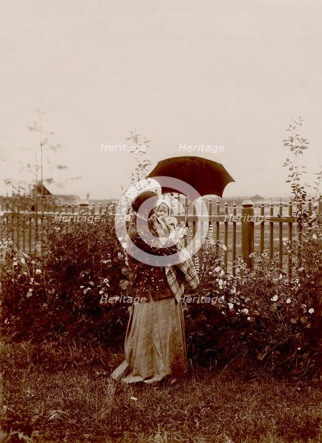 A walk in the garden at the Yudins' dacha in Tarakanovo, 1903. Creator: Unknown.