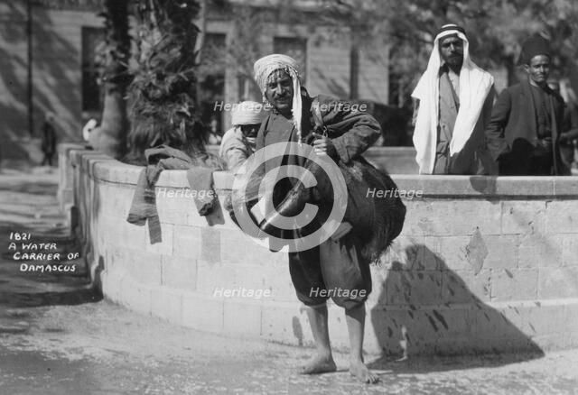 A water carrier in Damascus, Syria, c1920s-c1930s(?). Artist: Unknown