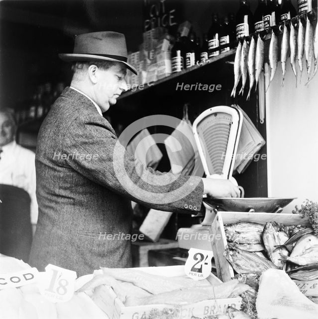A weights and measures officer, London, (c1950-c1970?). Creator: Henry Grant.