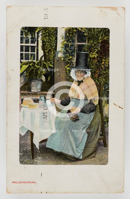 A Welsh woman at tea table with knitting on her lap, c1900. Creator: Unknown.