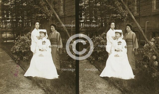A western Red Cross female doctor(?) and two Japanese women posed in a garden, c1905. Creator: Underwood & Underwood.