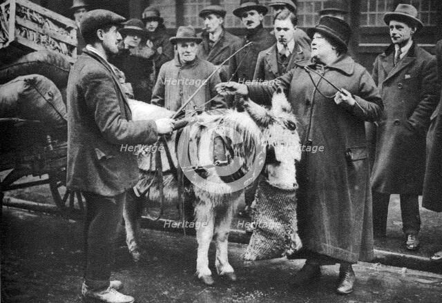 A 'whip woman', Covent Garden, London, 1926-1927.Artist: McLeish