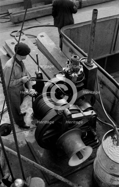A winchman at work on the River Thames, London, c1945-c1965. Artist: SW Rawlings