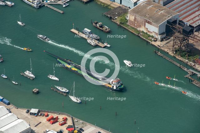A wind turbine blade aboard a barge, on the River Medina, Cowes, Isle of Wight, 2021 Creator: Damian Grady.