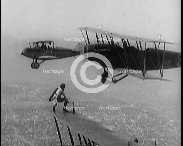 A Wing Walking Female Civilian Changes the Wheel of an Aeroplane in Flight, 1926. Creator: British Pathe Ltd.