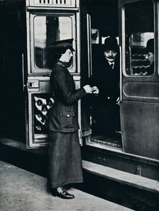 A woman ticket inspector at work, c1914