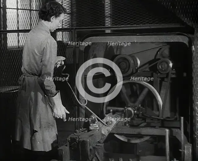 A Woman Using Factory Machinery, 1942. Creator: British Pathe Ltd.
