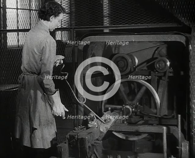 A Woman Using Factory Machinery, 1942. Creator: British Pathe Ltd.
