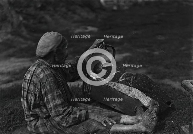 A woman with a cradle, 1890.  Creator: Unknown.
