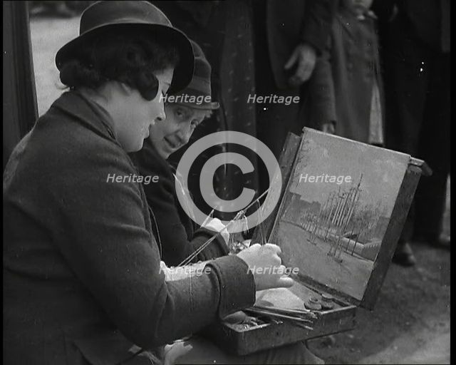 A Woman Artist Sitting at the Side of the Mall Painting the Scene While Watched By Several..., 1937. Creator: British Pathe Ltd.