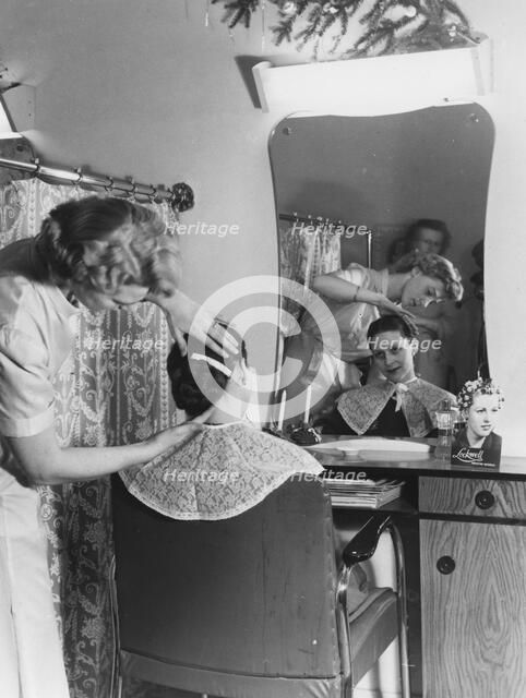 A woman at the hairdresser's, Sweden. Artist: Unknown