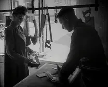 A Woman Buying Meat at a Butcher's Shop, 1942. Creator: British Pathe Ltd