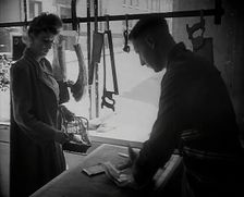A Woman Buying Meat at a Butcher's Shop, 1942. Creator: British Pathe Ltd