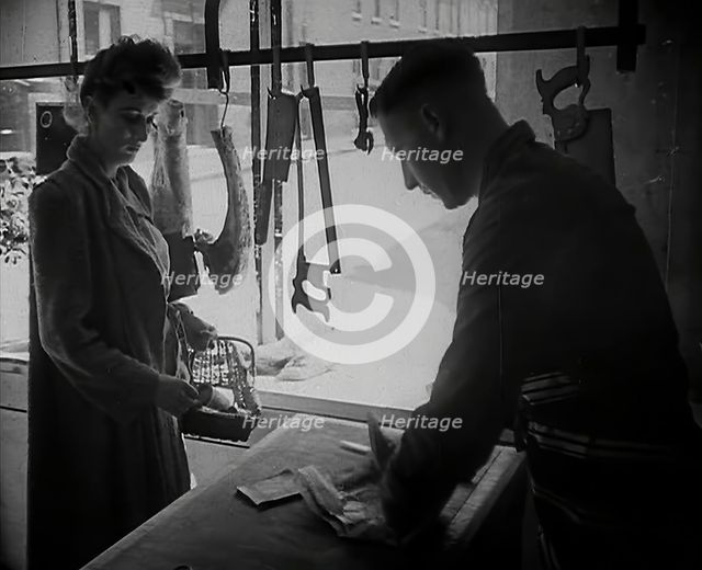 A Woman Buying Meat at a Butcher's Shop, 1942. Creator: British Pathe Ltd.