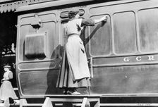 A woman cleaning railway carriages at Marylebone station, April 1915. Creator: Unknown