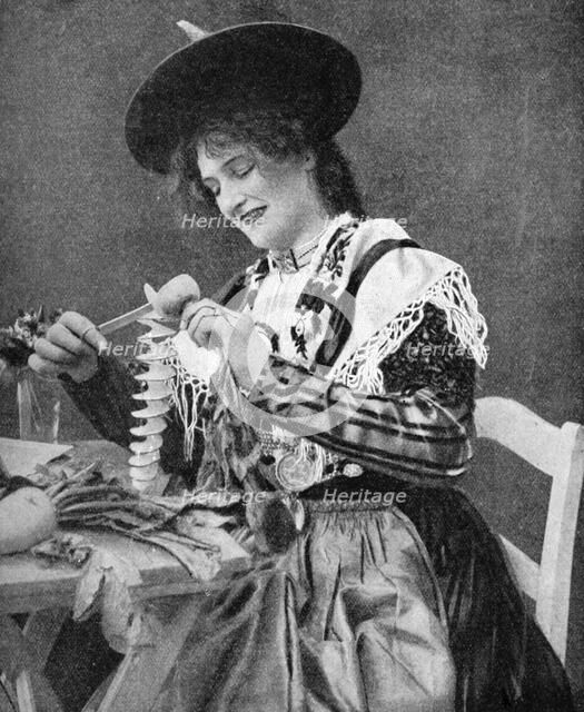A woman creatively peeling a potato, 1922. Creator: Georg Haeckel.