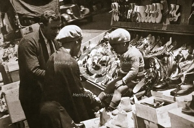 A woman from Harlem buys a pair of shoes for her child, New York, USA, c1920s-c1930s. Creator: Unknown.