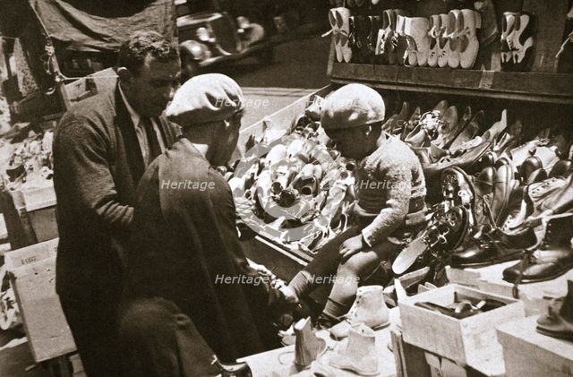 A woman from Harlem buys a pair of shoes for her child, New York, USA, c1920s-c1930s. Artist: Unknown