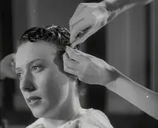 A Woman Having Her Hair Cut in the Victory Style, 1942. Creator: British Pathe Ltd