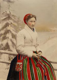 A woman in folk costume and white fur-trimmed jacket, 1886-1920. Creator: Helene Edlund