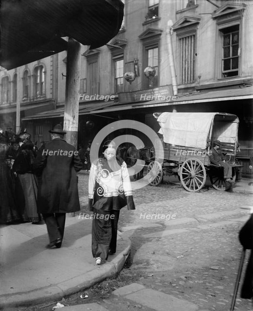 A woman in holiday attire, Chinatown, San Francisco, between 1896 and 1906. Creator: Arnold Genthe.
