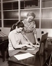 A woman is shown how to use an adding machine, York, Yorkshire, 1961