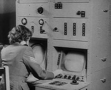 A Woman Operating a Radio, 1940. Creator: British Pathe Ltd