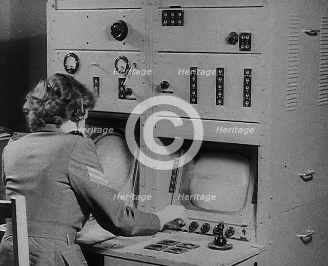 A Woman Operating a Radio, 1940. Creator: British Pathe Ltd.