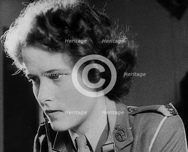 A Woman Operating a Radio, 1940. Creator: British Pathe Ltd.