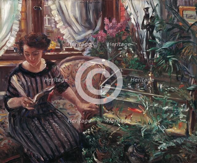 A Woman Reading near a Goldfish Tank, 1911. Creator: Corinth, Lovis (1858-1925).