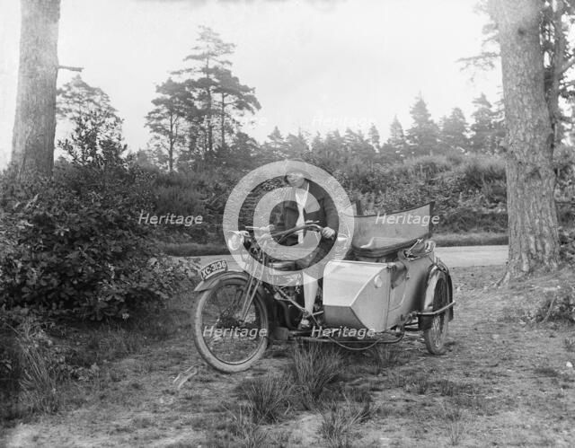 A woman riding a Douglas flat-twin motorcycle with a sidecar, 1900-1910. Artist: Unknown.