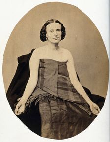 A woman seated; she is partially clothed with her arms extended and the left side of her..., c1865. Creator: L. Haase & Company
